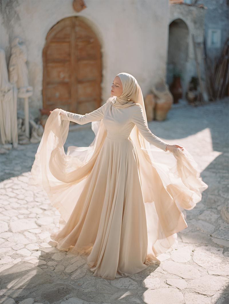 Bride twirling in a sunlit courtyard